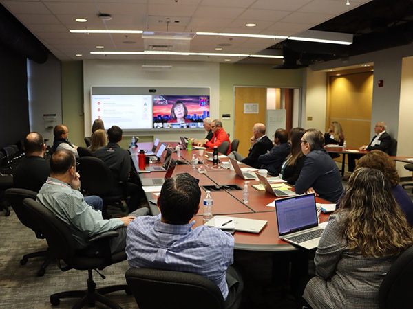 Internet2's Linda Roos on screen in conference room