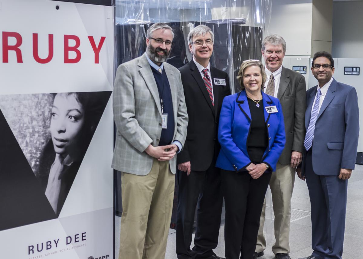 Officials pose next to the Ruby Cluster