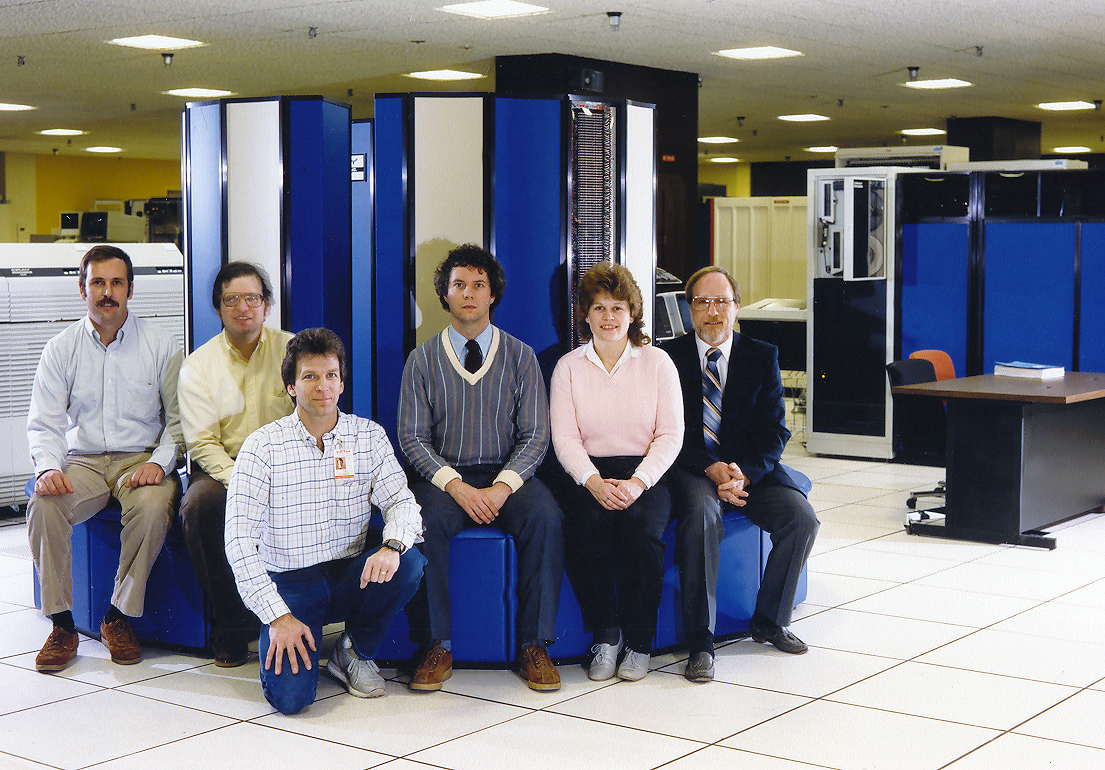 Cray staff sitting on the X-MP supercomputer installed at NASA-Lewis. Staff and vendors with the Cray X-MP.