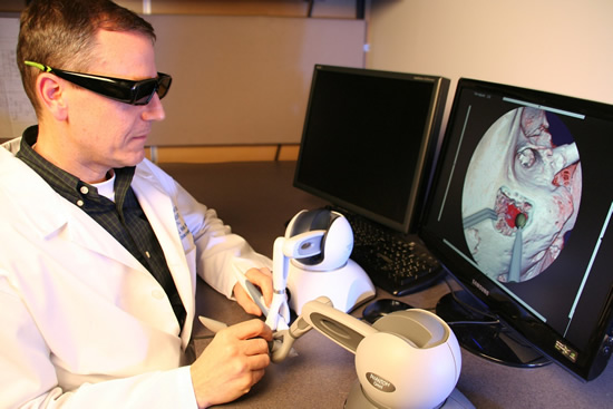 Dr. Wiet demonstrates the Virtual Temporal Bone surgery simulation system.